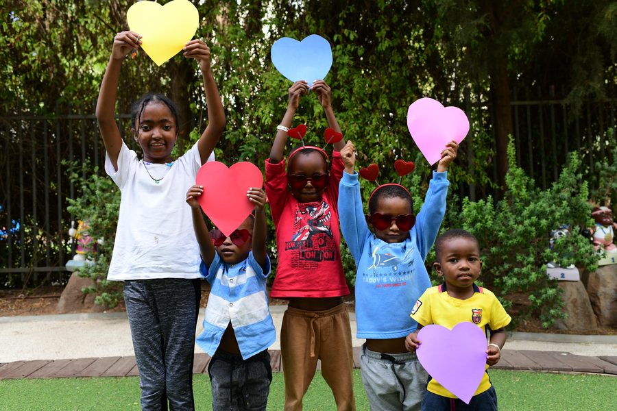 Children celebrating with paper hearts