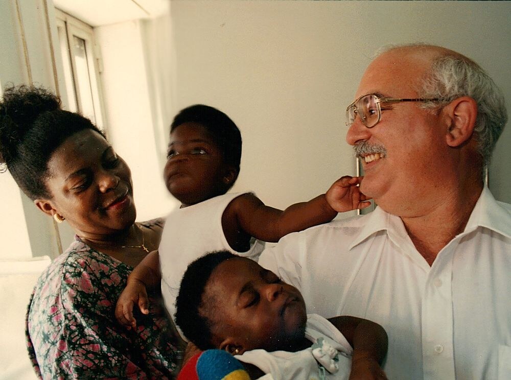 Dr. Amram (Ami) Cohen, Founder of Save a Child’s Heart, with a mother and child